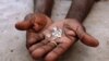 FILE - Illegal diamonds from Zimbabwe are displayed for sale in Manica, Mozambique.