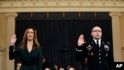 Jennifer Williams, an aide to Vice President Mike Pence, left, and National Security Council aide Lt. Col. Alexander Vindman, are sworn in to testify before the House Intelligence Committee on Capitol Hill in Washington, Nov. 19, 2019, during a public imp