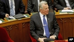 Hungarian President Pal Schmitt, who announced on Monday that he will resign from his post, waits before delivering a speech at the parliament in Budapest, Hungary, April 2, 2012.