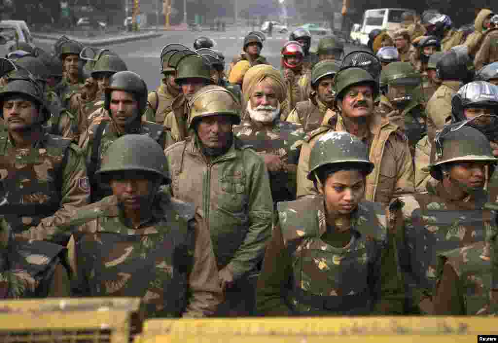 Police keep guard during a protest rally in New Delhi December 27, 2012. Several hundred people gathered in India's capital on Thursday in a bid to rekindle mass protests over the gang rape and ferocious beating of a young woman, who was airlifted to Sing