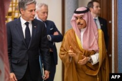 FILE—A handout picture released on the Saudi Ministry of Foreign Affairs official X account of March 20, 2024, shows Saudi Foreign Minister Prince Faisal bin Farhan (R) receiving US Secretary of State Antony Blinken in Jeddah.