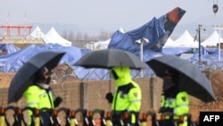 Tarpaulin covers shroud the wreckage of the Jeju Air Boeing 737-800 aircraft, which on Dec. 29 crashed and burst into flames at Muan International Airport in Muan, South Korea, on Jan. 5, 2025.