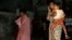 Local women who rushed outdoors following tremors speak on their cellphones, in Kolkata, India, April 13, 2016. A strong earthquake struck Myanmar on Wednesday night and was felt in parts of eastern India and Bangladesh.