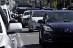 FILE - Heavy traffic is seen in the Ocean Beach neighborhood of San Diego, California, ahead of the Fourth of July holiday, July 3, 2020.