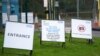 Signs offer directions outside a COVID-19 drive through test center in Bidston, England, Oct. 12, 2020.