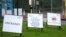 Signs offer directions outside a COVID-19 drive through test center in Bidston, England, Oct. 12, 2020.
