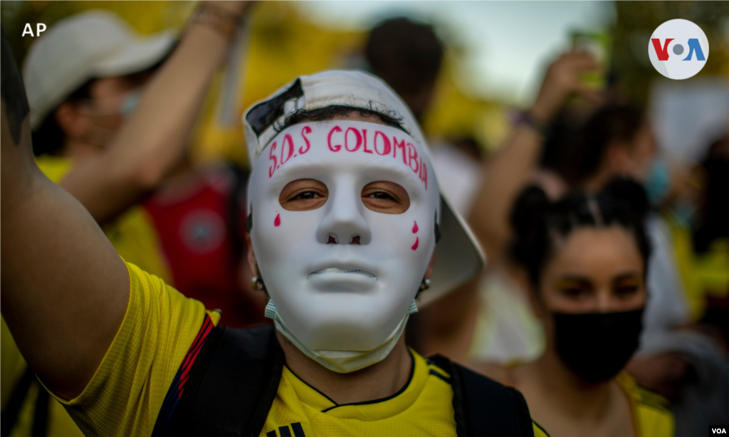 Un hombre con una m&#225;scara que dice: &quot;SOS Colombia&quot; participa durante una protesta contra la violencia en Colombia. Madrid, Espa&#241;a, 6 de mayo de 2021.