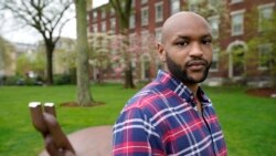 Brown University graduate Jason Carroll, stands for a portrait on the Brown campus in Providence, R.I., on Tuesday, May 4, 2021, near the Slavery Memorial. (AP Photo/Steven Senne)