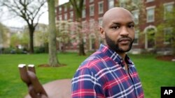 Brown University graduate Jason Carroll, stands for a portrait on the Brown campus in Providence, R.I., on Tuesday, May 4, 2021, near the Slavery Memorial. (AP Photo/Steven Senne)