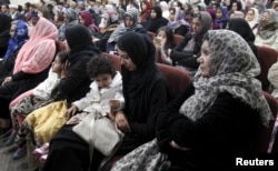 FILE - Women and children attend the Ahmadiyya Muslim Community USA members prayer vigil for the victims of Wednesday's massacre at the San Bernardino's Baitul Hameed Mosque in Chino, Calif., Dec. 3, 2015.