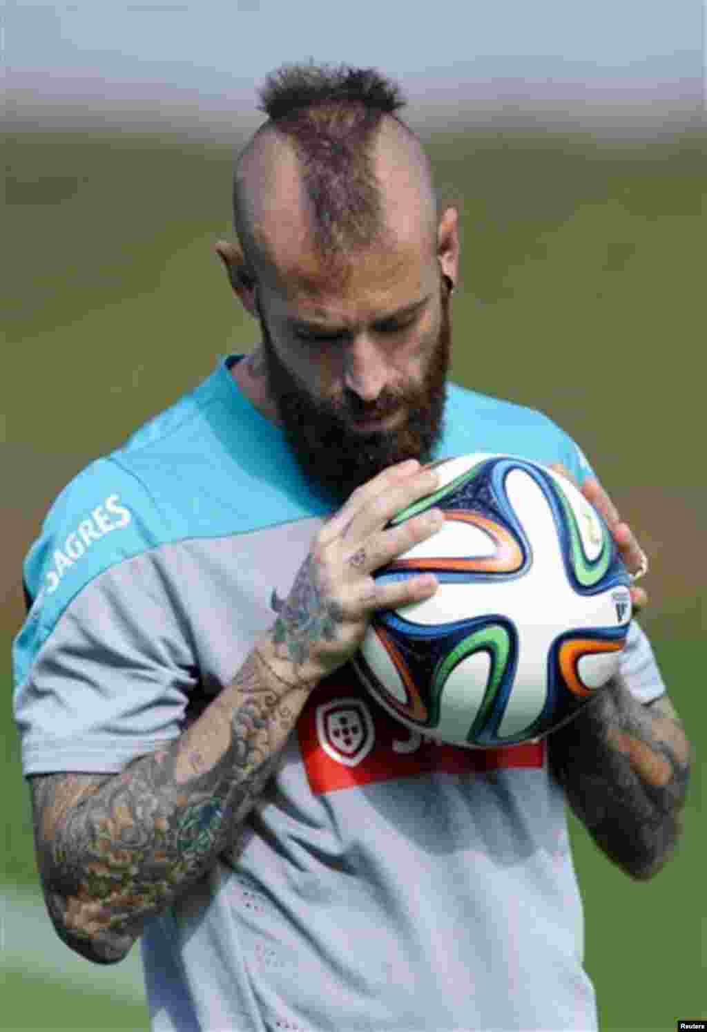 Raul Meireles grabs the ball during a training session of Portugal in Campinas, Brazil, Thursday, June 19, 2014. Portugal plays in group G of the Brazil 2014 soccer World Cup. (AP Photo/Paulo Duarte)