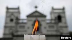 A candle burns outside St. Anthony's Shrine a week after a string of suicide bomb attacks across the island on Easter, in Colombo, Sri Lanka, April 28, 2019.