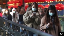 People wear face masks and walk at a shopping mall in Taipei, Taiwan, Jan. 31, 2020.