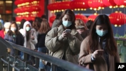 People wear face masks and walk at a shopping mall in Taipei, Taiwan, Jan. 31, 2020.