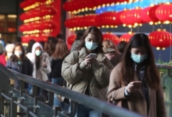 People wear face masks and walk at a shopping mall in Taipei, Taiwan, Jan. 31, 2020.