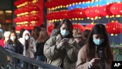 People wear face masks and walk at a shopping mall in Taipei, Taiwan, Jan. 31, 2020.