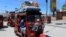Residents ride in rickshaws as they flee following renewed clashes between rival factions in the security forces, who have split in a dispute over an extension to the president's term in Hodan district of Mogadishu, Somalia, April 27, 2021.