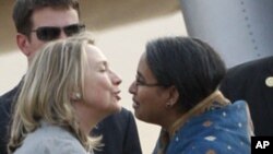 U.S. Secretary of State Hillary Rodham Clinton, left, is greeted by Bangladeshi Foreign Minister Dipu Moni upon her arrival in Dhaka, Bangladesh, May 5, 2012. 