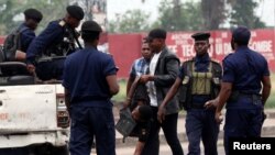 A policeman detains a demonstrator during a protest organized by Catholic activists in Kinshasa, Democratic Republic of Congo, Jan. 21, 2018. 