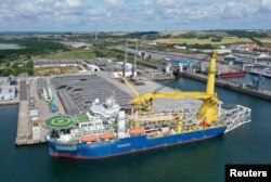 FILE - The Russian pipe-laying vessel Akademik Cherskiy, which may be used to complete the construction of the Nord Stream 2 gas pipeline, lies in the port of Mukran, Germany, July 7, 2020.