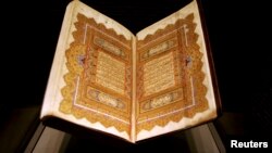 Pages from a copy of the Quran dating back to 1284 are displayed at an exhibition in Doha, Qatar, Dec. 2, 2008.