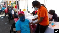 FILE - A patient receives a Johnson & Johnson vaccine in Soweto, South Africa, Aug. 20, 2021. 