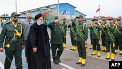 A handout picture made available by the Iranian presidential office on February 2, 2024 shows Iranian President Ebrahim Raisi (3rd L) visiting the Iranian revolutionary guards corps (IRGC) navy base in Bandar Abbas, southern Iran. (Photo by Iranian Presid