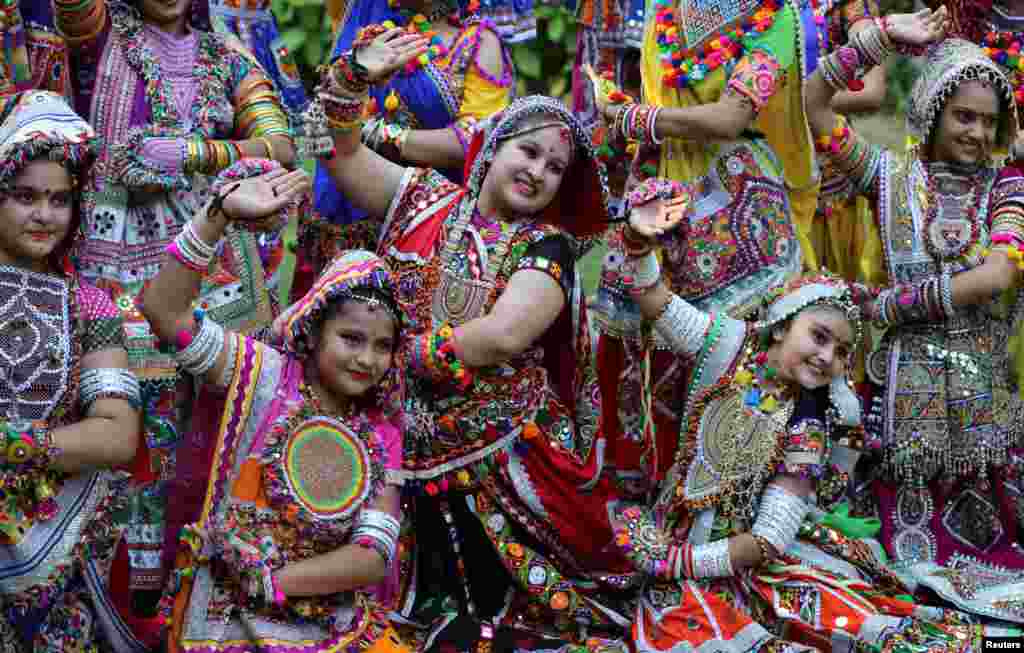 Participants dressed in traditional attire pose during rehearsals for Garba, a folk dance, ahead of Navratri, a festival during which devotees worship the Hindu goddess Durga and youths dance in traditional costumes, in Ahmedabad, India.