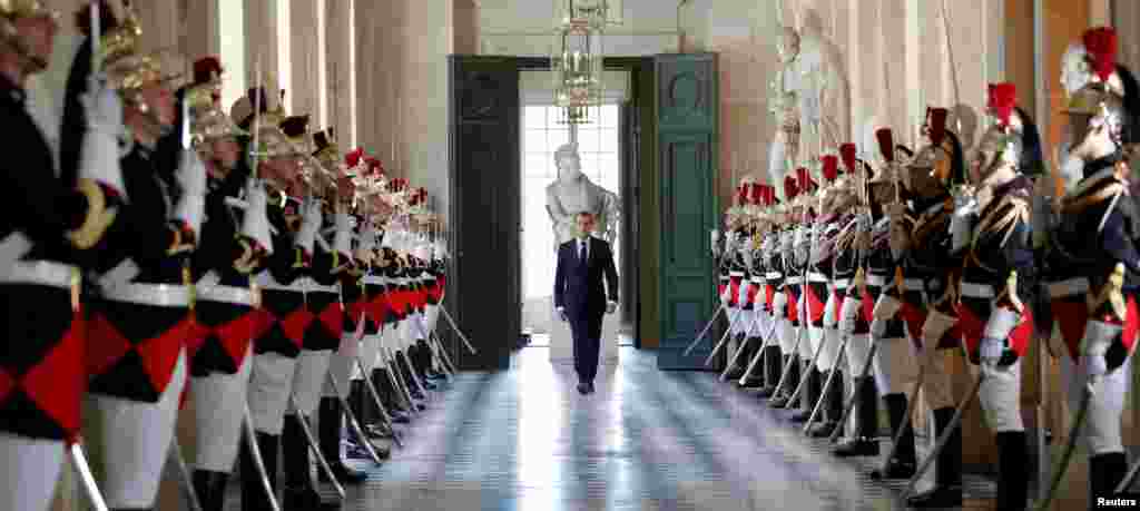 French President Emmanuel Macron walks through the Galerie des Bustes (Busts Gallery) to access the Versailles Palace&#39;s hemicycle to address both the upper and lower houses of the French parliament (National Assembly and Senate) at a special session in Versailles near Paris.