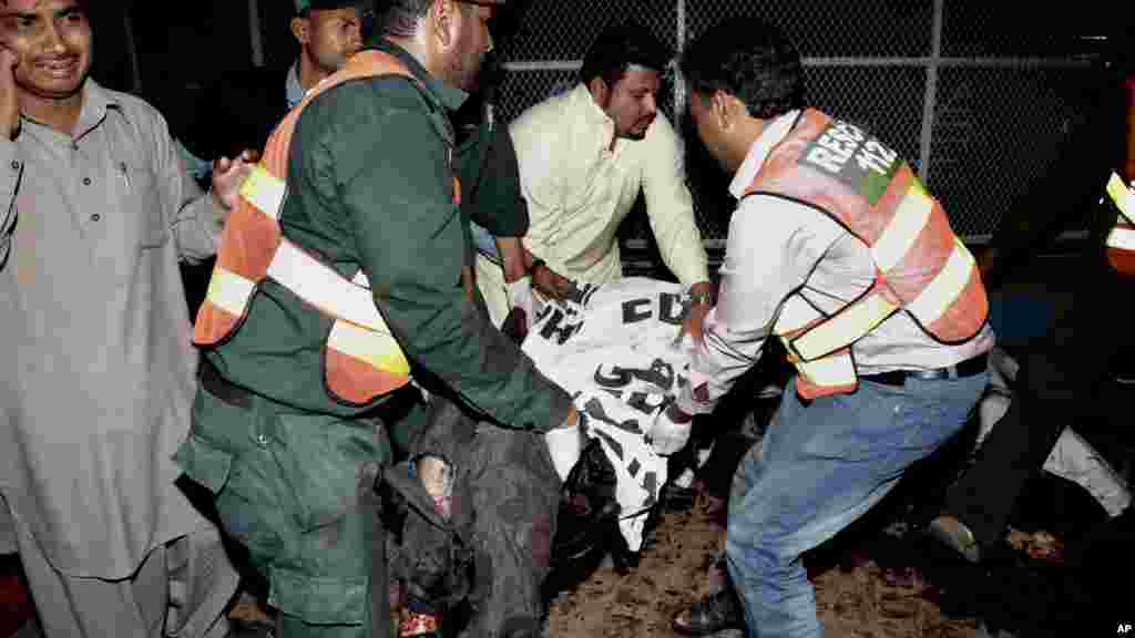 Des secouristes pakistanais évacuent le corps d'une des victimes de l'attentat de Lahore, Pakistan, 27 mars 2016.