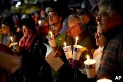 Community members gather on Nov. 2, 2023, during a candlelight vigil in Auburn, Maine, to remember victims in a mass shooting in Lewiston on Oct. 25.