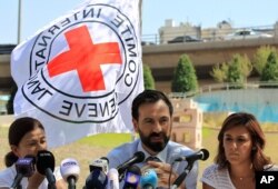 FILE - Fabrizzio Carboni, center, head of the International Committee for the Red Cross in Lebanon, speaks during a press conference in front of the United Nations Headquarters in Beirut, Lebanon, July 1, 2016.