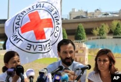 FILE - Fabrizzio Carboni, center, head of the International Committee for the Red Cross in Lebanon, speaks during a press conference in front of the United Nations Headquarters in Beirut, Lebanon, July 1, 2016.