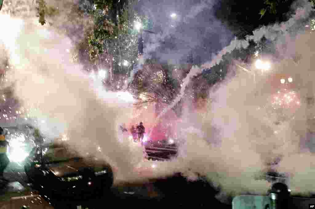 Smoke fills the sky as federal officers try to disperse Black Lives Matter protesters on Wednesday, July 22, 2020, in Portland, Oregon.