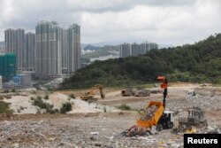 A truck unloads garbage at a landfill at Tseung Kwan O district in Hong Kong, China, June 9, 2017.