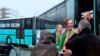 Rikko Voorberg, second right, smiles as he talks to activists preparing to drive a convoy of cars and a bus to Greece to pick up migrants from island camps, in Utrecht, Netherlands, Friday, Dec. 21, 2018. 