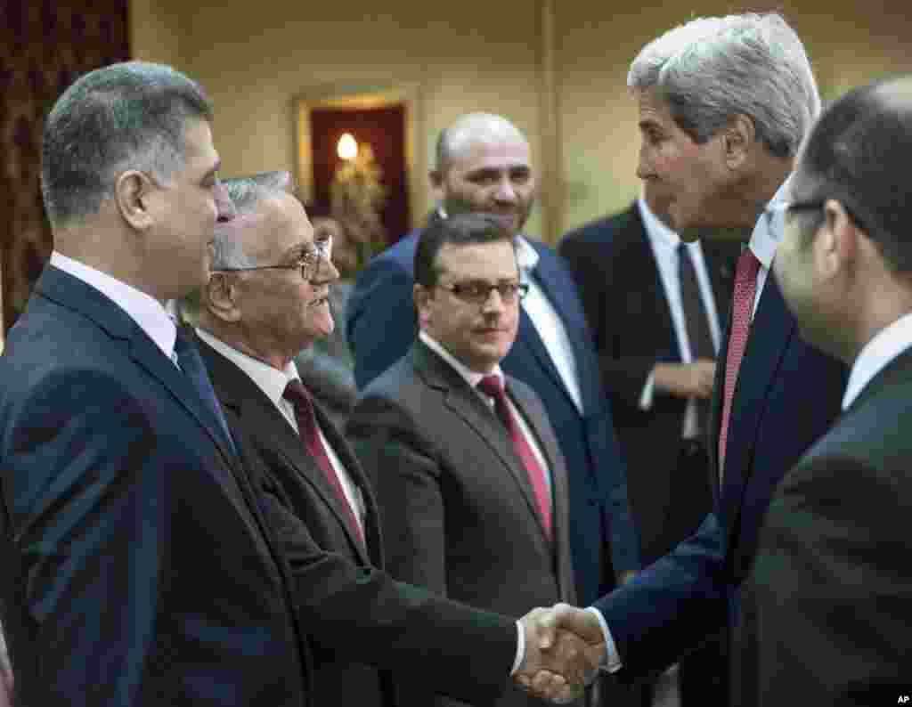 U.S. Secretary of State John Kerry, right, is greeted by members of Iraq's parliament and other leaders before a meeting with the Speaker of the Iraqi Parliament Salim al-Jabouri, far right, in Baghdad, Iraq, Sept. 10, 2014. 