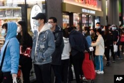 People line up to enter a supermarket hours before a citywide curfew is introduced in Melbourne, Sunday, Aug 2, 2020.