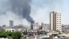 Smoke rises from buildings hit by shelling in Homs, Syria