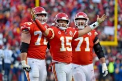 Kansas City Chiefs' Patrick Mahomes (15) celebrates a touchdown pass with Eric Fisher (72) and Mitchell Schwartz (71) during the second half of the NFL AFC Championship football game against the Tennessee Titans, Jan. 19, 2020, in Kansas City.