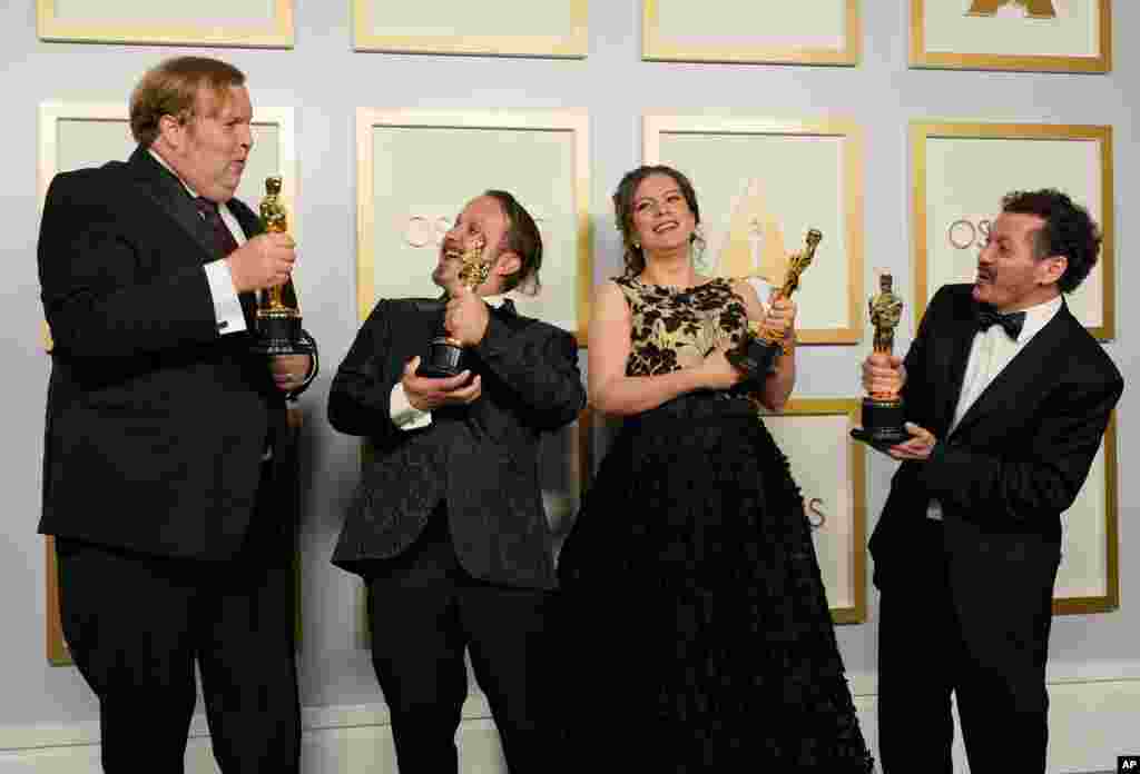 Phillip Bladh, from left, Carlos Cortes, Michellee Couttolenc and Jaime Baksht, winners of the award for best sound for &quot;Sound of Metal,&quot; pose in the press room at the Oscars on Sunday, April 25, 2021, at Union Station in Los Angeles. (AP Photo…