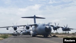 Spanish military plane and military vehicles depart on tarmac as Spanish diplomatic personnel and citizens are evacuated, in Khartoum