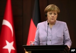 German Chancellor Angela Merkel listens during a press conference with Turkey's Prime Minister Binali Yildirim after their meeting in Ankara, Turkey, Feb. 2, 2017.