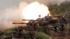 FILE- In this May 25, 2017, file photo, a line of U.S. M60A3 Patton tank fire at targets during the annual Han Kuang exercises on the outlying Penghu Island, Taiwan.