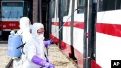 Members from an emergency anti-epidemic headquarters in Mangyongdae District, disinfect a tramcar of Songsan Tram Station to prevent new coronavirus infection in Pyongyang, North Korea, Feb. 26, 2020.