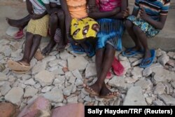 FILE - Girls sit in the yard at Kalas Girls Primary School, Amudat District, Karamoja, Uganda, Jan. 31, 2018. They each escaped home after their families tried to force them to undergo FGM or to enter into marriage.