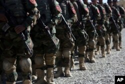 New members of the Afghan Special forces attend their graduation ceremony at the Afghan Corp, on the outskirts of Kabul, Afghanistan, Oct. 25, 2017.