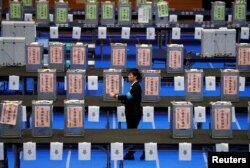 An election official waits for the start of ballot counting for Japan's lower house election at a counting centre in Tokyo, Japan, Oct. 22, 2017.