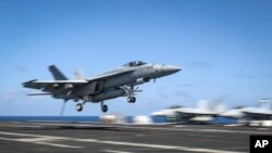 An F/A-18E Super Hornet lands on the flight deck of the Nimitz-class aircraft carrier USS Abraham Lincoln in the Arabian Sea, May 20, 2019. 