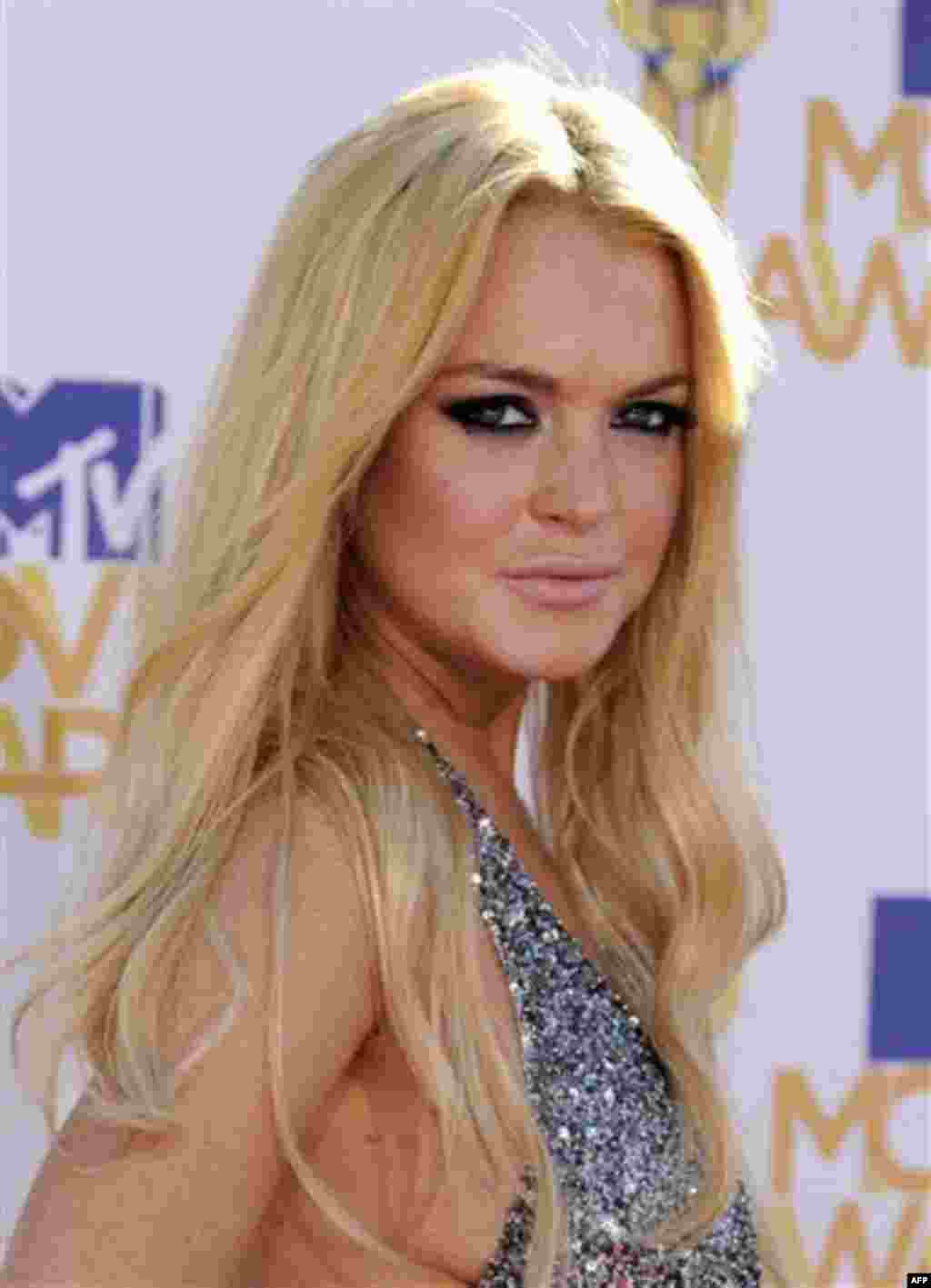 FILE - In this June 6, 2010 file photo, Lindsay Lohan arrives at the MTV Movie Awards in Universal City, Calif. (AP Photo/Chris Pizzello, file)